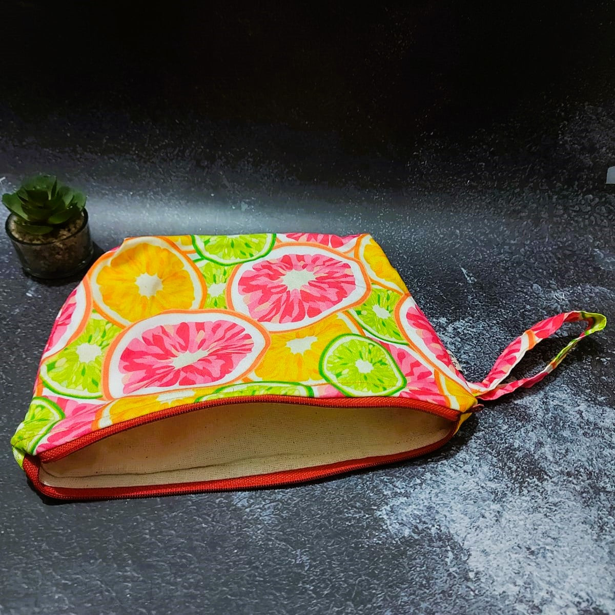 Orange, fuity print fabric Hand stiched Pouch.