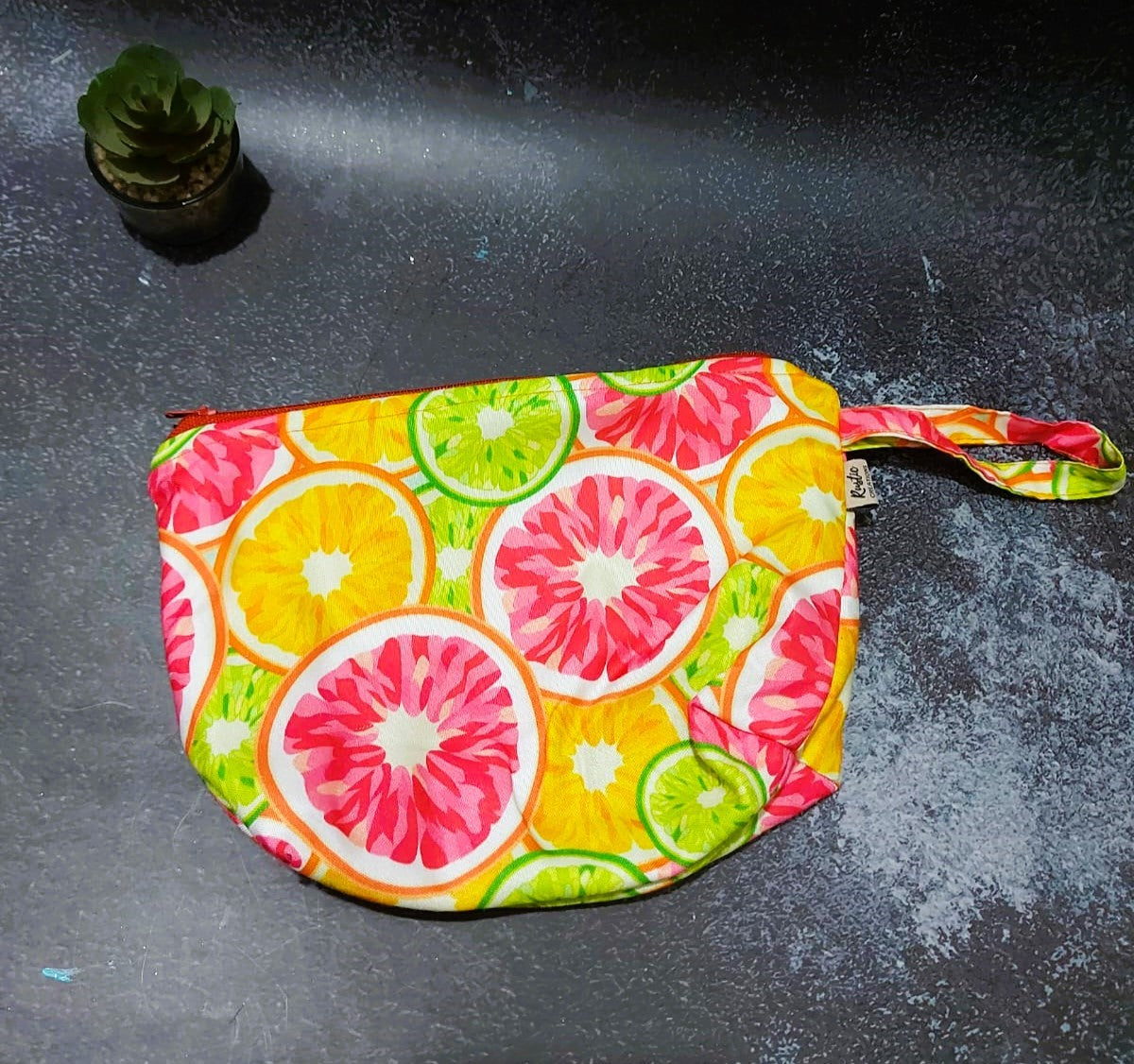 Orange, fuity print fabric Hand stiched Pouch.